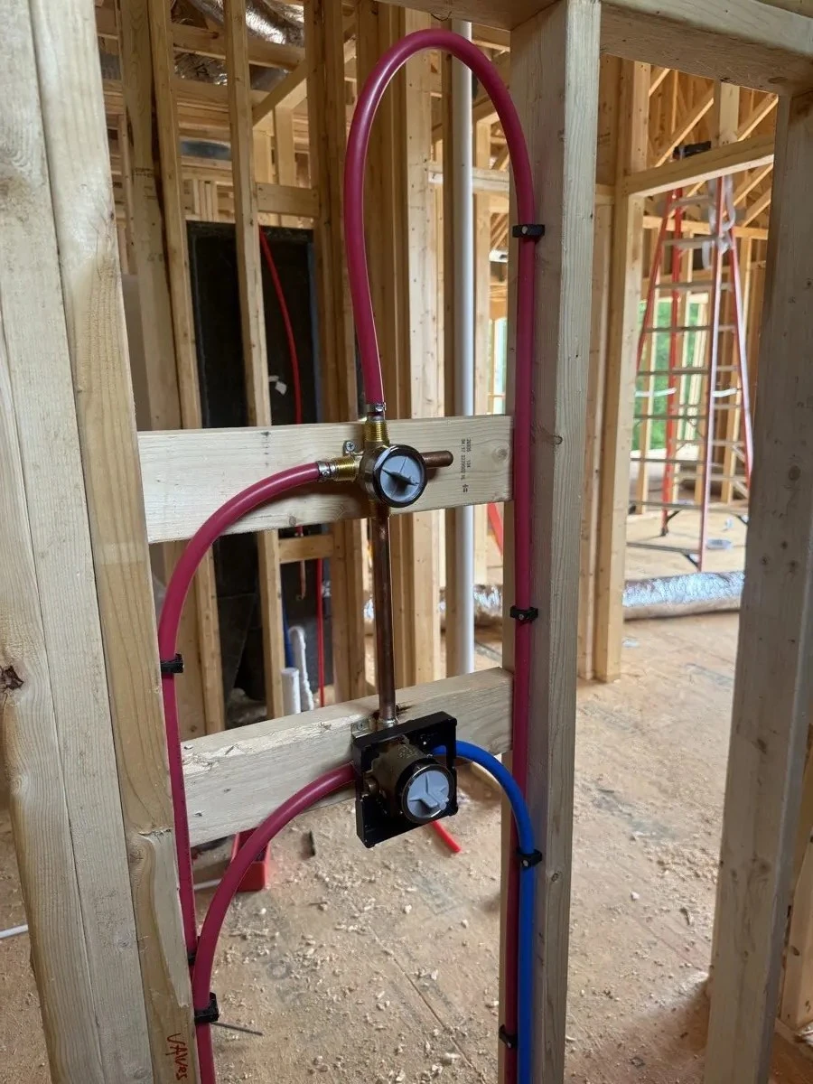 Shower valve rough-in with red and blue water-supply tubing